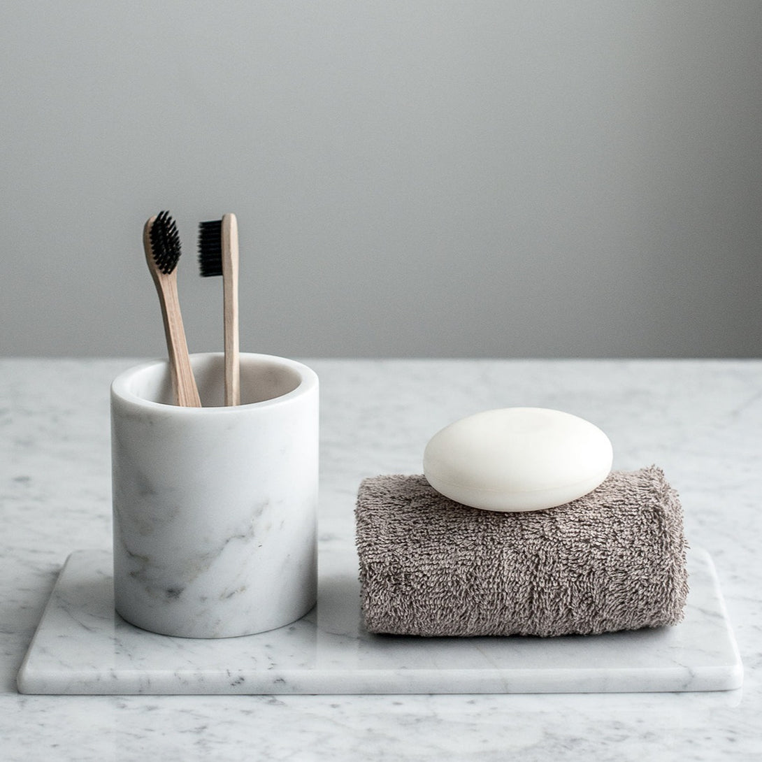 Luxurious Italian Marble Cup [luxxdesign.com]: A touch of elegance for your morning routine. Indulge in the smooth perfection of this handcrafted Italian marble toothbrush holder. Shop designer marble objects at luxxdesign.com.